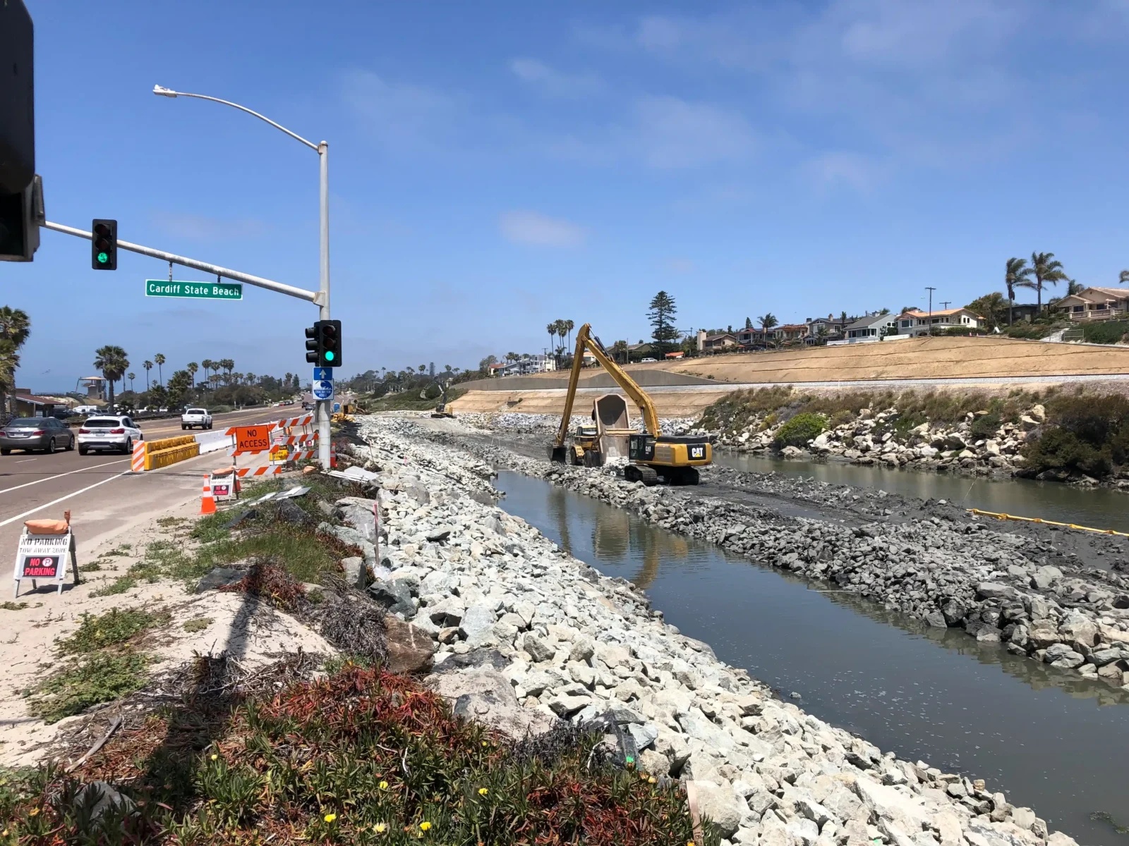 Marine construction and shoreline restoration project at Cardiff State Beach showing rock placement and channel management.